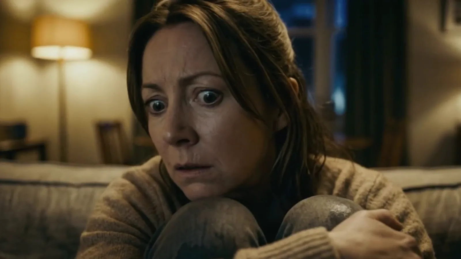 Hugging her knees, terrified. Amazon Prime.