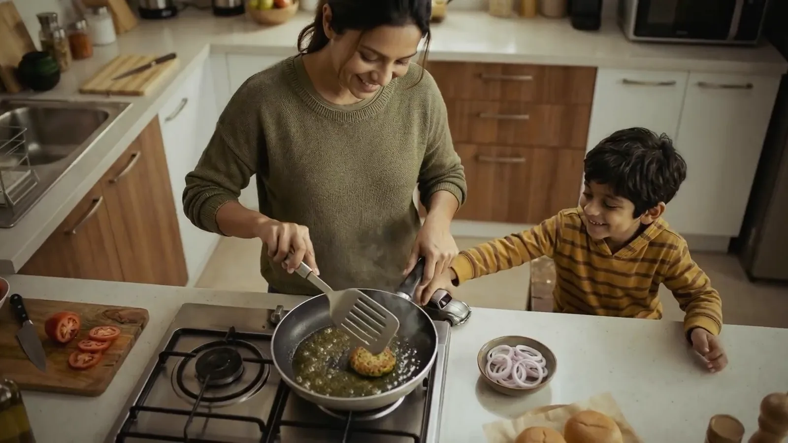 Mum cooks, son watches. Burger King.